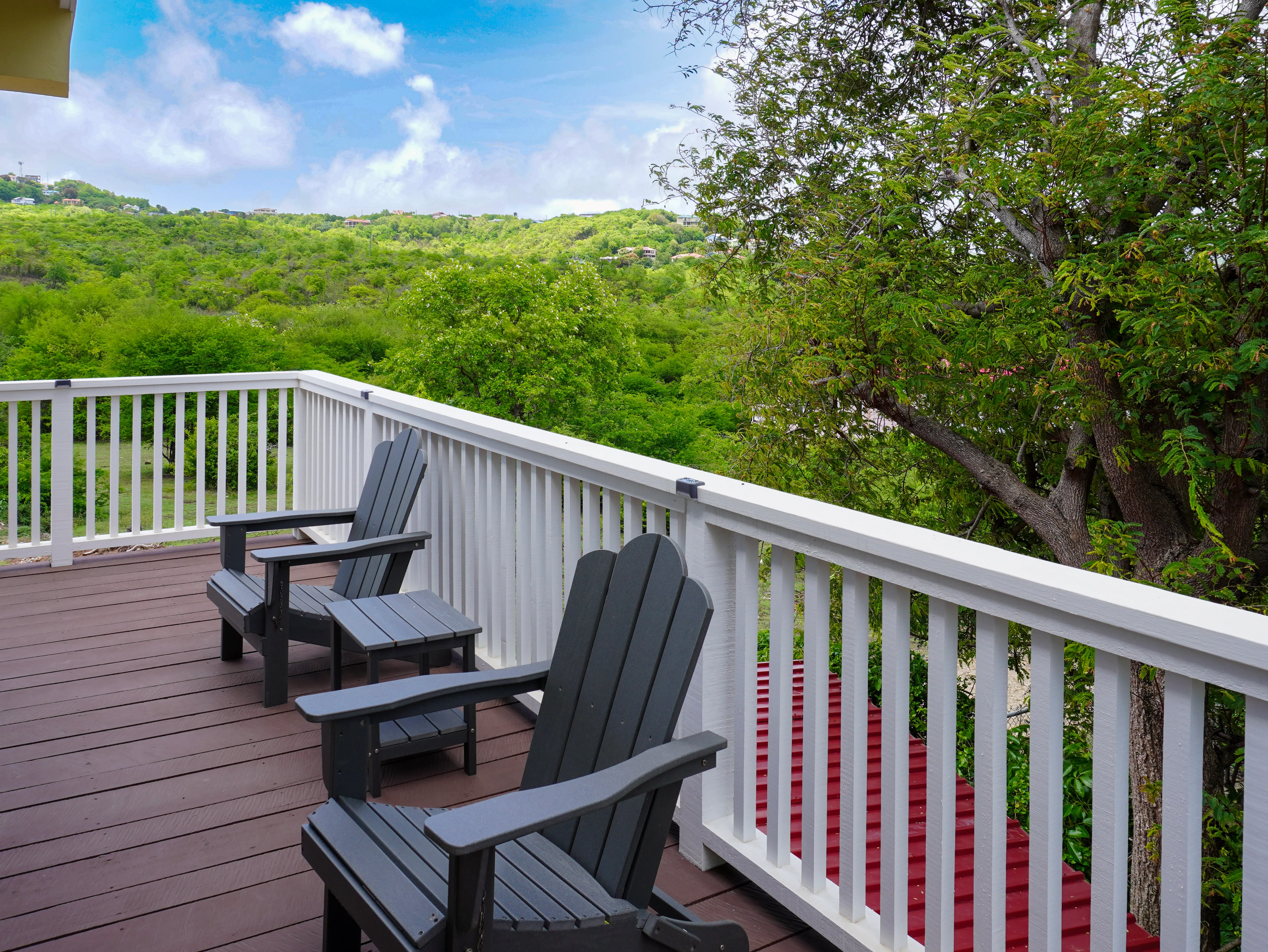 Private balcony overlooking green hills and trees