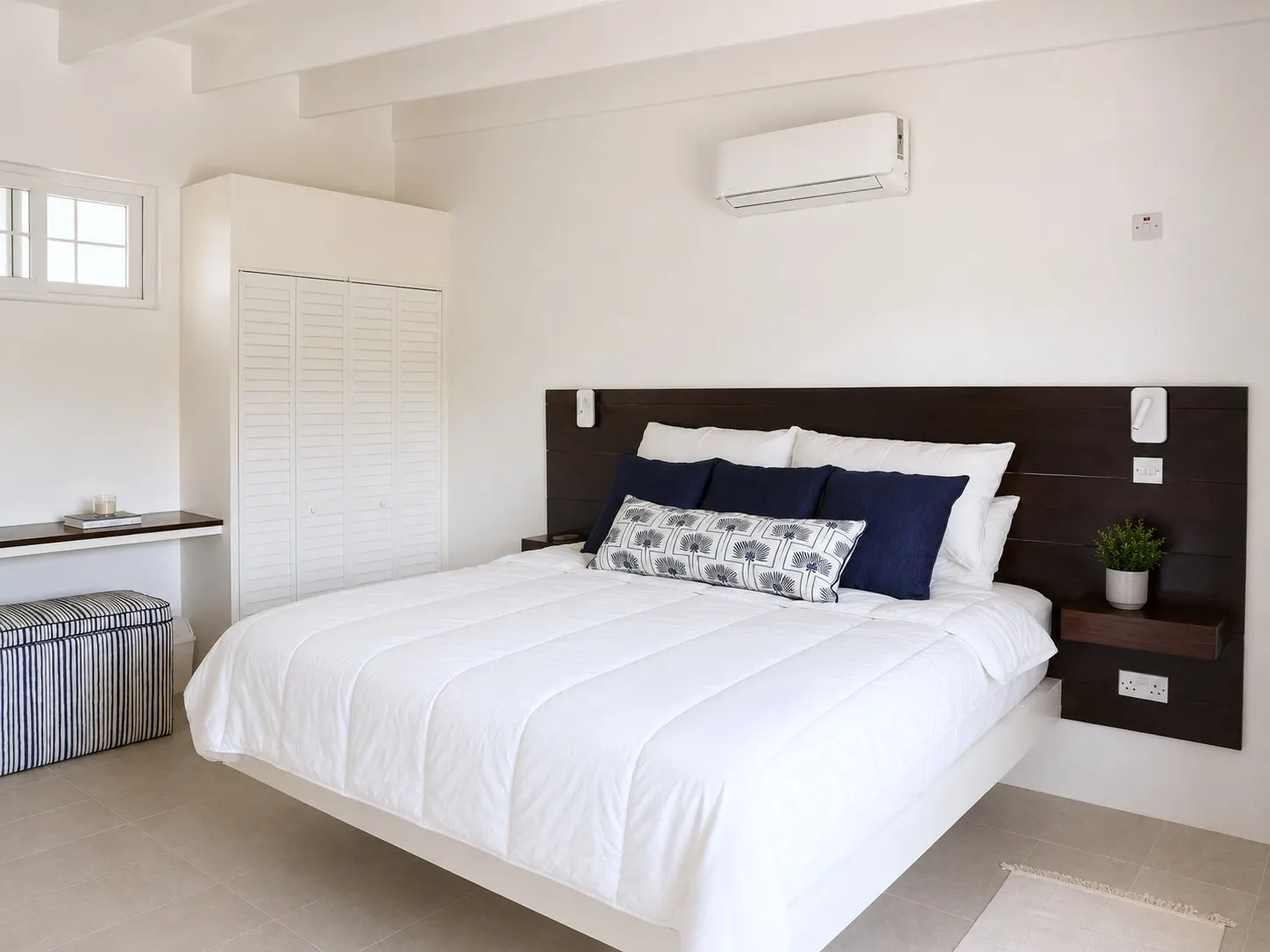 King bedroom with navy accent pillows